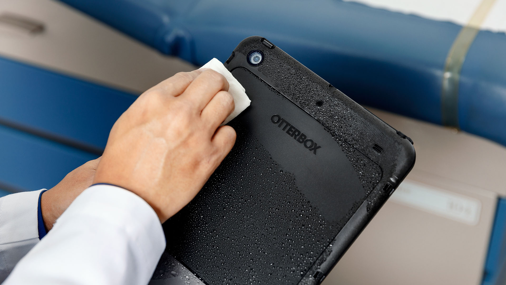 Person wiping off a tablet case