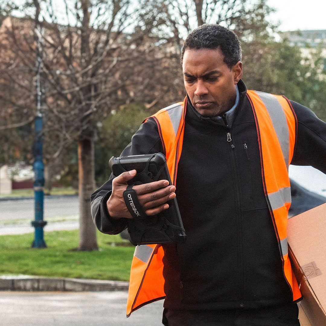 Man holding tablet while delivering a box.