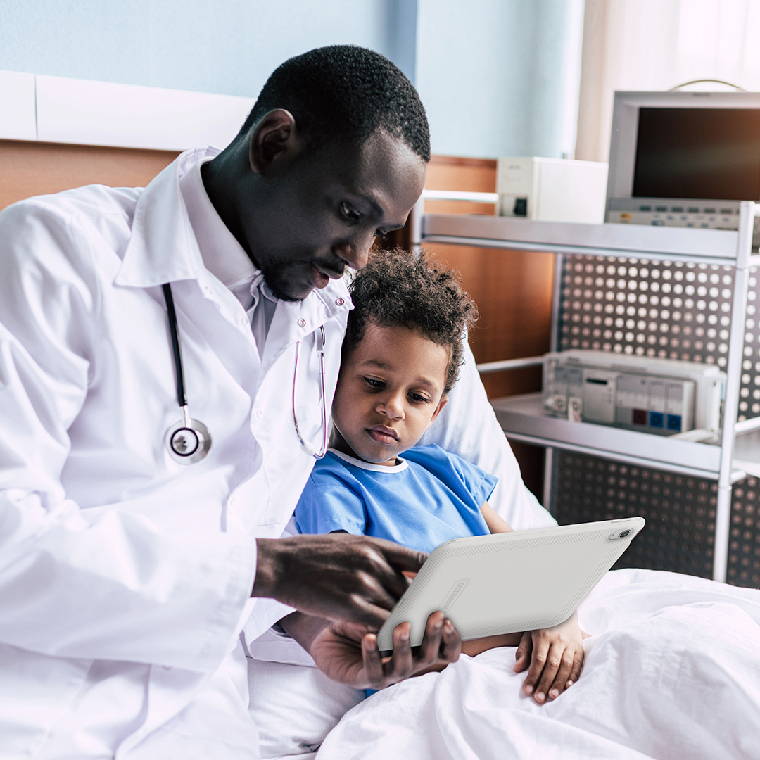 Doctor and child patient reviewing tablet